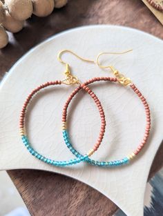 Teal and sienna glass beaded hoop earrings with gold hook // 1 1/2" diameter + Style name: Sienna + beaded hoop earrings with teal and brown glass seed beads with gold accent + Hoops are 1 1/2" +/- diameter or 2" +/- + gold hoops with matching earwire see more liz.cor.creative beaded hoop earrings here https://www.etsy.com/shop/lizcorcreative?ref=seller-platform-mcnav§ion_id=42427009 If there is a particular color that you would like to see please message me + All lizcorcreative hoop earrings wi Everyday Colorful Beaded Round Earrings, Brown Beaded Hoop Earrings, Everyday Hoop Beaded Earrings With Ear Wire, Czech Glass Beaded Earrings With Ear Wire, Czech Glass Round Beaded Earrings With Ear Wire, Brown Beaded Hoop Earrings As Gift, Brown Beaded Hoop Earrings For Gift, Tortoise Shell Jewelry, Boho Drop Earrings