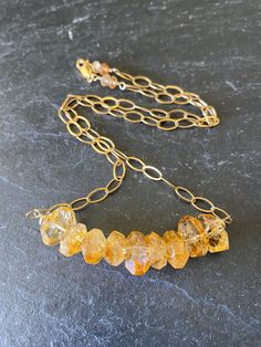 "A beautiful chunky necklace for November babies or for those who love Citrine! Who wouldn't? It's a wonderful golden color that sparkles when you move.  There are petite hessonite garnets that finish off the end of the necklace. A great necklace to wear alone or layer with your other chains. Necklace length can be adjusted, just let me know. ::Details:: ~citrine stones are organic nugget shaped, faceted for sparkle ~petite hessonite garnets are wire wrapped at the end of the necklace ~necklace Everyday Gold Birthstone Necklace Handmade, Handmade Gold Birthstone Necklace For Everyday, Everyday Handmade Gold Birthstone Necklace, Gold Necklaces With Natural Stones For Anniversary, Amber Birthstone Necklace For Anniversary, Gold Crystal Necklace With Gemstone For Anniversary, Spiritual Gold Crystal Necklace For Anniversary, Personalized Gold Crystal Necklace Spiritual Style, Personalized Gold Crystal Necklaces For Spiritual Use