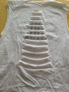 the back of a white shirt that is cut out and ready to be sewn