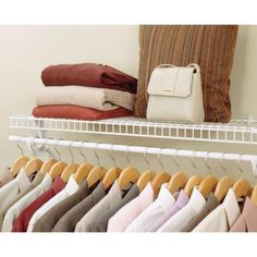 a rack with clothes and pillows on it