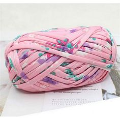 a ball of pink yarn with flowers on it