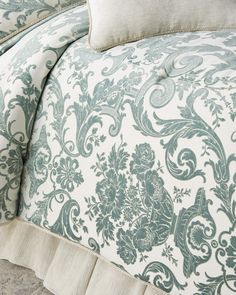 the comforter is made up with blue and white floral designs on it's sides