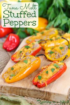 three stuffed mini bell peppers on a cutting board