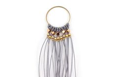 an image of a necklace with beads and chains hanging from it's side on a white background