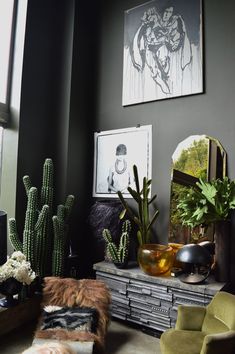 a living room filled with furniture and plants