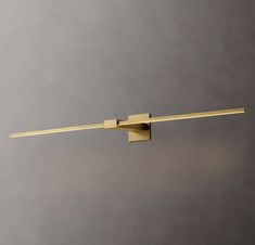 an image of a modern bathroom light fixture on the wall with dim lighting in it