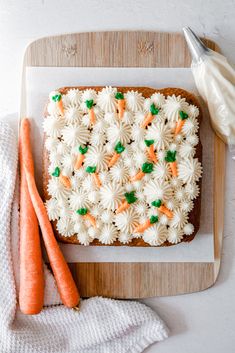 carrots and white frosting on top of a cake