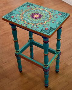 a small wooden table with an intricate design on it's top and bottom legs