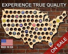 a wooden united states map with beer caps on it and the words experience true quality made in usa on sale