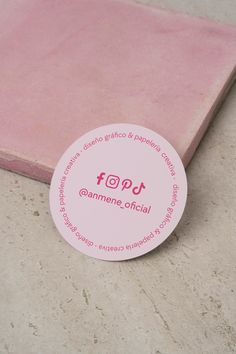 a pink sticker sitting on the ground next to a piece of paper that says stop