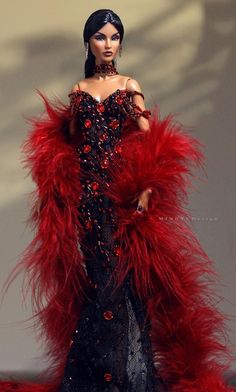 a barbie doll wearing a red and black dress with feathers on it's shoulders