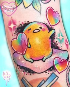 an image of a colorful tattoo on someone's leg with hearts and stars around it