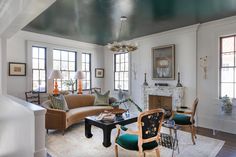 a living room filled with furniture and lots of windows