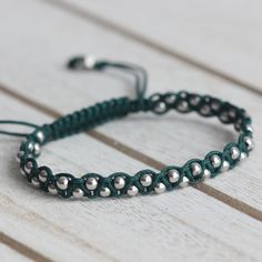 3 mm Rhodium Plated 925 Sterling Silver BeadsAdjustable Length (14 cm to 23 cm)Cord Color: Dark Green Green Braided Bracelets With Sliding Knot And Round Beads, Minimalist Silver Beaded Bracelets For Everyday, Modern Handmade Beaded Bracelets With Round Beads, Handmade Green Braided Bracelets With Round Beads, Adjustable Beaded Sterling Silver Bracelet, Sterling Silver Beaded Bracelet, Adjustable, Modern Handmade Silver Beaded Bracelets, Adjustable Beaded Sterling Silver Bracelet For Everyday, Modern Handmade Beaded Bracelets