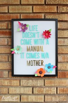 a sign that says life doesn't come with a manual it comes way mother