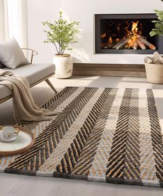 a living room with a fire place in the fireplace and rugs on the floor