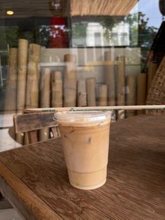 a plastic cup sitting on top of a wooden table