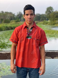 This beautiful Traditional Guayabera for Men has colorful embroidered details and adds a sophisticated flare to your wardrobe. This elegant button up Shirt is perfect for special occasions such as Mexican Fiestas, Quinceañeras, Weddings, etc. Traditional Cotton Camp Shirt With Short Sleeves, Traditional Summer Shirt With Camp Collar, Casual Red Shirt For Festivals, Traditional Red Short Sleeve Shirt, Traditional Red Summer Shirt, Red Cotton Short Sleeve Shirt With Camp Collar, Traditional Fit Short Sleeve Shirt, Traditional Red Short Sleeve Top, Traditional Red Top With Short Sleeves