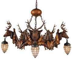 a chandelier with deer heads hanging from it's sides and three lights on each side