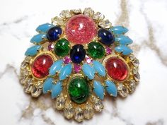 Christian Dior Brooch from 1967!  Great signed piece.  It is signed Christian Dior 67 Germany.  This is a nice collectible piece!  Great colors and really good stone colors.  Gold tone setting!  Mint vintage condition. More details please refer to the photos.