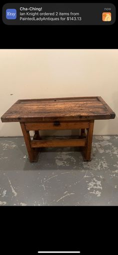 a wooden table sitting on top of a gray floor