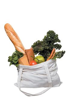 a white bag filled with vegetables and bread