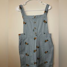 Light Blue Overalls - Pants Buttons On The Top Do Not Actually Button Small Zipper On The Side Super Cute Floral Pattern Adjustable Straps Light Blue Buttoned Bottoms For Spring, Light Blue Casual Bottoms With Buttons, Casual Light Blue Bottoms With Button Closure, Light Blue Casual Bottoms With Button Closure, Light Blue Overalls, Spring Button-up Overalls With Button Closure, Fitted Button-up Overalls With Pockets, Cute Blue Bib Front Overalls, Spring Denim Blue Button-up Overalls