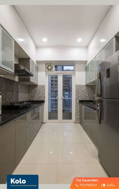 an empty kitchen with stainless steel appliances and white tile flooring is pictured in this image