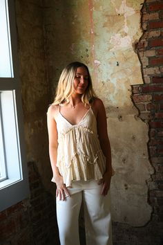 The Daniela Top is like a ray of sunshine - light, airy, and full of playful ruffles. Made with woven cotton gauze and featuring a flattering V-neck, delicate spaghetti straps, and a touch of quirkiness, this top is the perfect addition to your summer wardrobe. Cotton Spaghetti Straps Tank Top With Ruffles, Sleeveless Bohemian Top With Ruffle Hem, Chic Cotton Camisole With Ruffled Straps, Bohemian Sleeveless Top With Ruffle Hem, Beige Ruffled Tank Top For Summer, Cotton Camisole With Ruffled Straps For Summer, Summer Cotton Camisole With Ruffled Straps, Cotton Ruffled Camisole For Day Out, Cotton Ruffle Camisole For Day Out