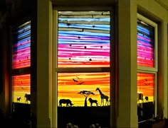 an image of a window with animals painted on the glass and in front of it