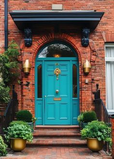 a blue front door with two planters on either side and an entry way leading to it