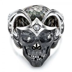 #101968 Galatea Jewelry by Artist is available at Joseph Jewelry.This striking ring features a skull carved in sterling silver with a prong set diamond in the forehead and a... Luxury Sterling Silver Skull Ring, Formal Gothic Skull Ring, Luxury Carved White Gold Rings, Gothic Skull Ring For Formal Occasions, Formal White Gold Skull Ring, Luxury Skull Ring As Gift, Symbolic White Gold Skull Ring For Anniversary, Symbolic Engraved White Gold Skull Ring, Luxury Silver Skull Ring For Formal Occasions