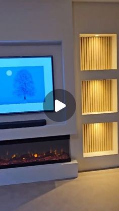 a flat screen tv mounted to the side of a wall next to a fire place