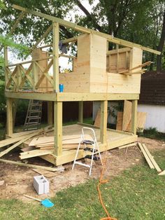 a wooden house being built in the yard