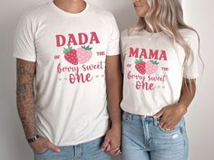 a man and woman standing next to each other wearing matching tshirts that read,'dad of the berry sweet one '