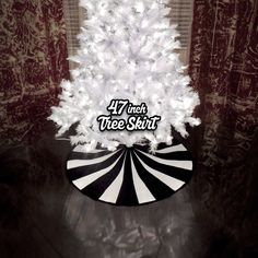 a white christmas tree sitting on top of a black and white floor