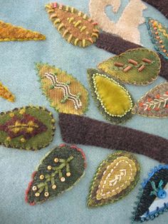 a close up of many different types of appliques on a piece of cloth