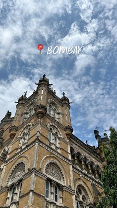 a tall building with a red balloon in the sky above it that says bomb bay