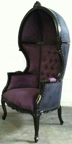 an old fashioned chair with purple and blue upholstered