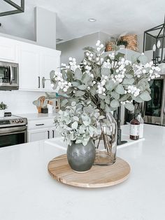 a vase filled with flowers sitting on top of a counter