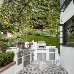 an outdoor kitchen with black and white tile flooring