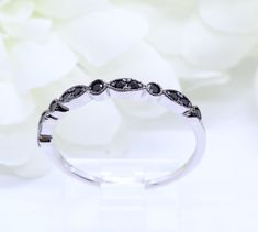 "Make a purchase of $50 or more and receive 10% Off Use Coupon Code \"JOON10OFF\" Ring Specifications: Metal: Sterling Silver Metal Purity: 92.5% Band Width: 1.5mm Gemstone: Simulated Black Diamond Gemstone Creation Method: Simulated Design: Art Deco Plating: N/A Gift Box Included Don't know your ring size? Here you can find a link to a conversion table of all ring sizes of all country's: (copy & paste into your browser) http://pics.bluenile.com/assets/chrome/pdf/ring_sizing_guide_0610-CA.pd Black Diamond Band Ring, Black Diamond Bands, Onyx Engagement Ring, Conversion Table, Art Deco Wedding Band, Deco Wedding, Art Deco Wedding, Diamond Rings Bands, Ring Sizes