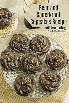 chocolate cupcakes on a plate with frosting and sprinkles