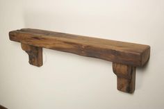 a wooden shelf mounted to the side of a wall