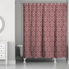 a bathroom with a red shower curtain next to a white dresser and mirror on the wall