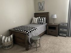 a bed room with a neatly made bed and two nightstands next to each other