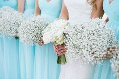 the bridesmaids are holding their bouquets with baby's breath