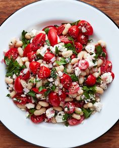 a white plate topped with beans and tomatoes