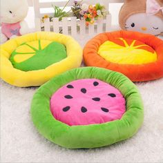 three pet beds with watermelon and butterfly on them