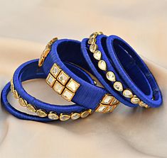 Blue silk thread handmade bangles with kundan stones. You may choose size 2.4 or 2.6 Components: silk thread plastic bangles Blue Silk Thread Bangles, Kundan Kada, Fabric Bangles, Kundan Work, Plastic Bangles, Silk Jewelry, Silk Thread Bangles, The Bangles, Thread Bangles